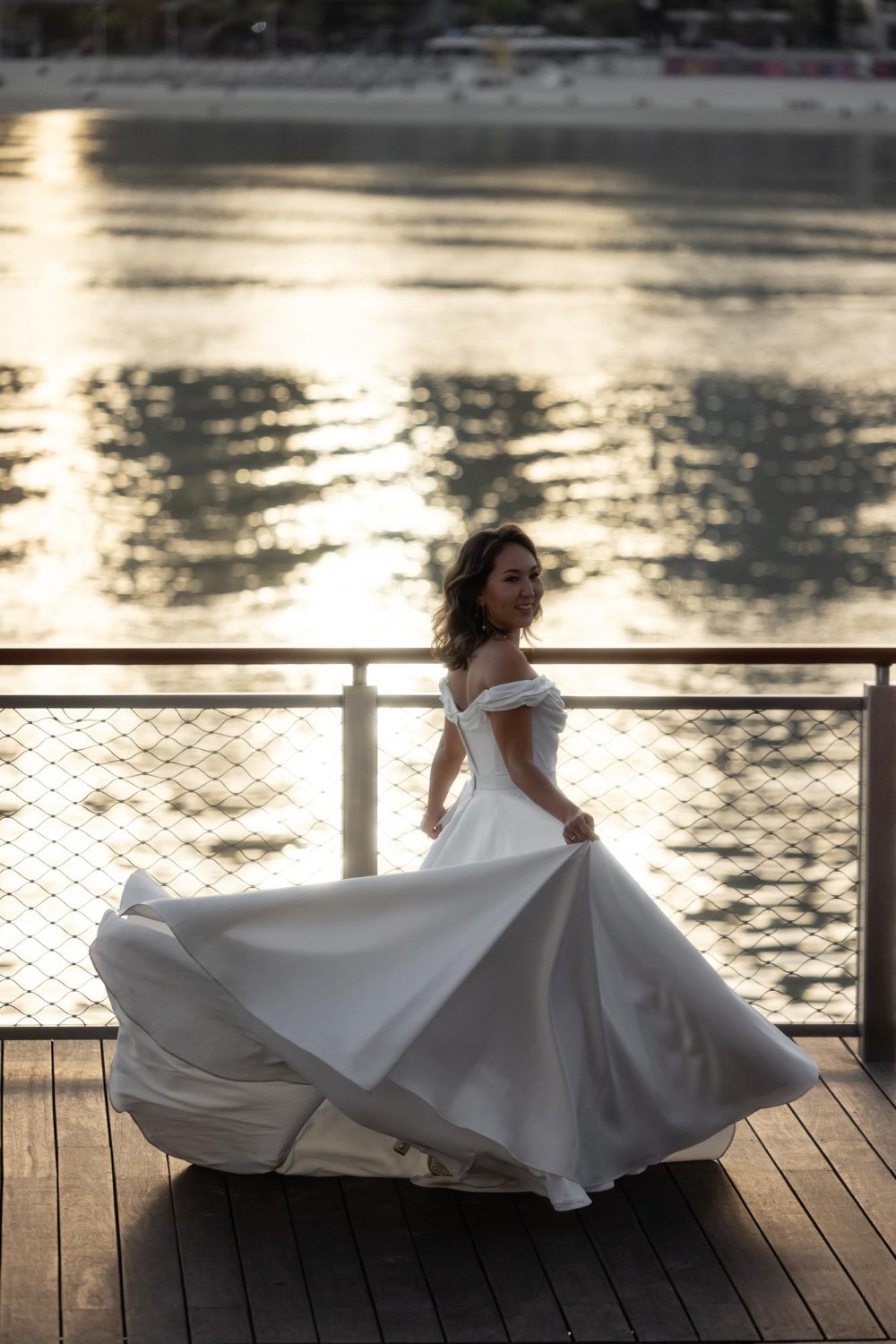 Happy young bride woman in white dress running