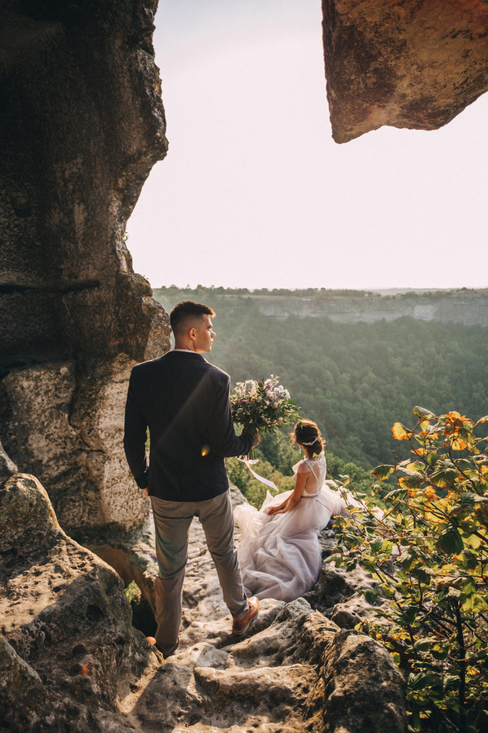 Wedding photo shoot at mountain Mangup in Crimea Portrait of loving couple newlyweds at sunset light
