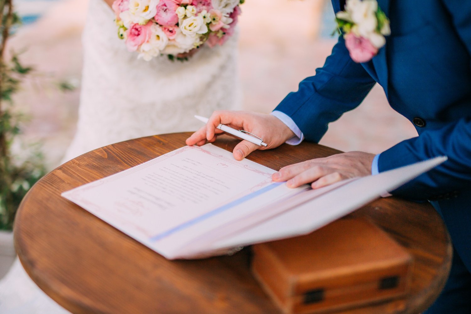 Newlyweds put their signatures in the act of registering a marriage