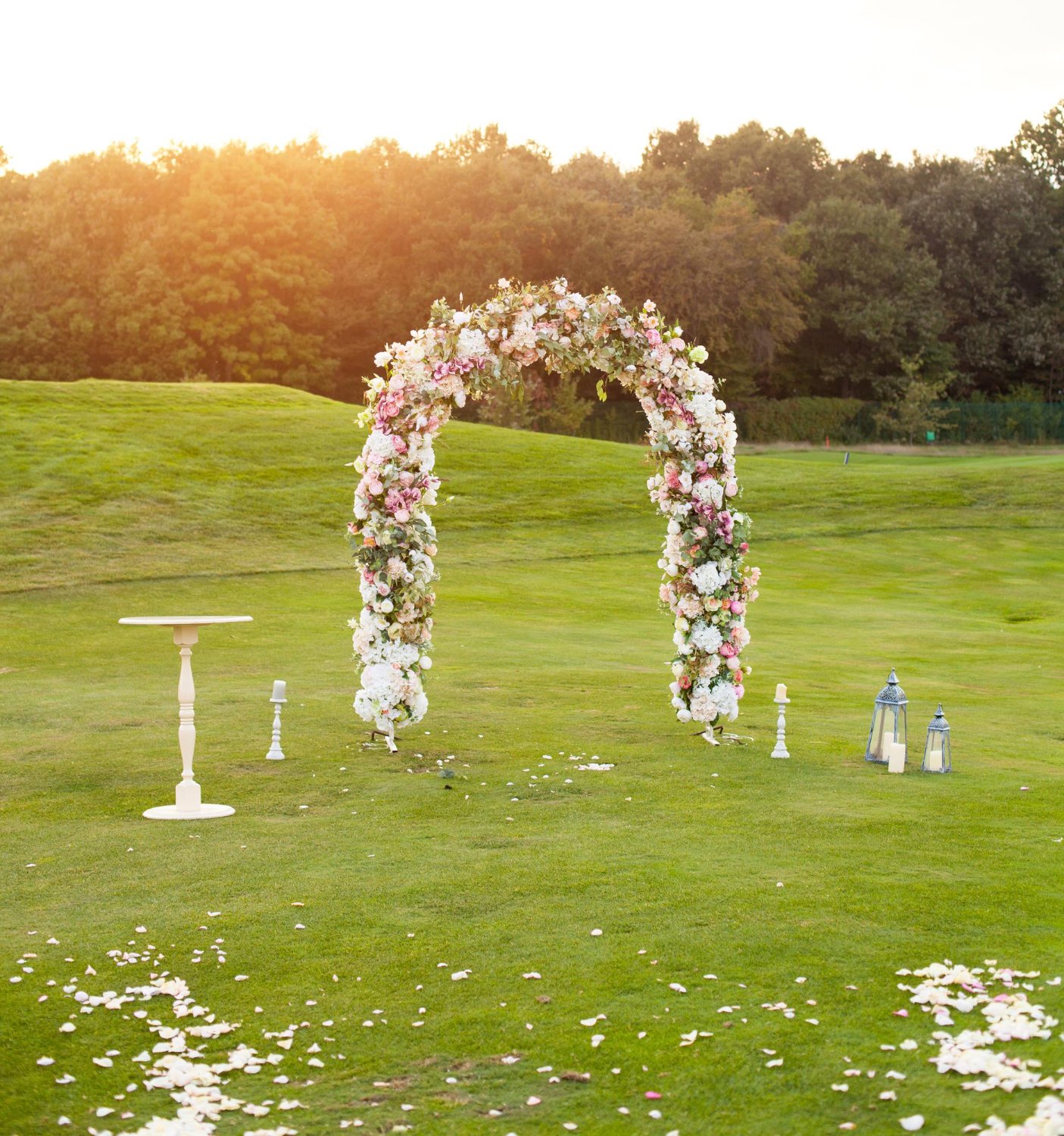  beautiful floral arch with lots of small purple pink and white flowers on the green field