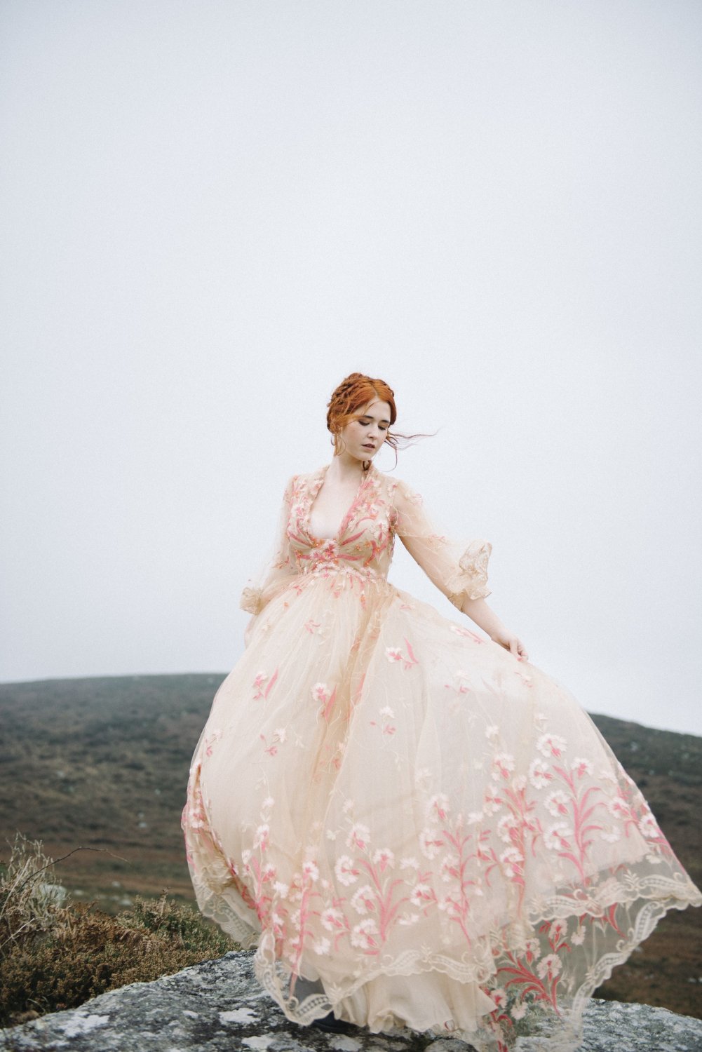 ginger female with a pure white skin in an attractive pink gown