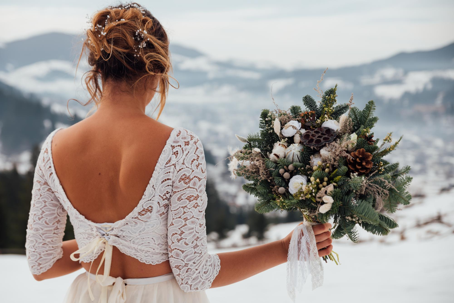  bride in white wedding dress holding colorful flowers bouquet