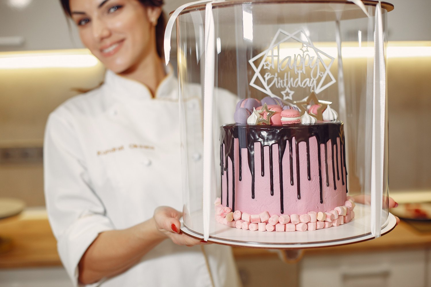photo confectioner in a uniform decorates the cake