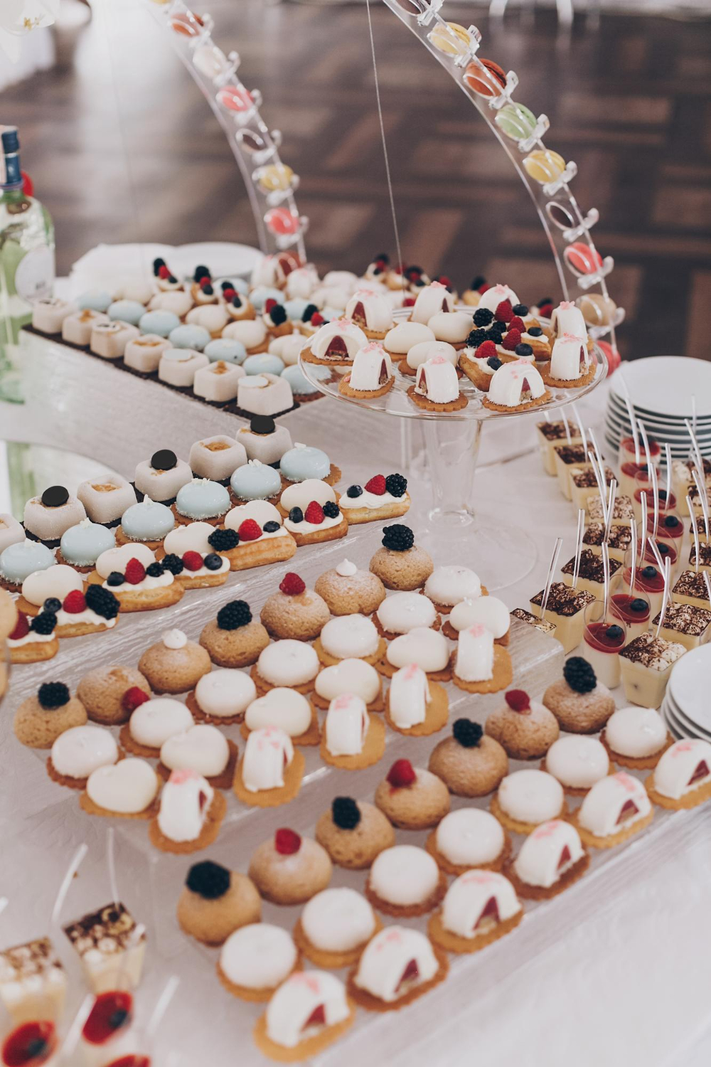 delicious creamy desserts with fruits macarons cakes and cookies on table at wedding