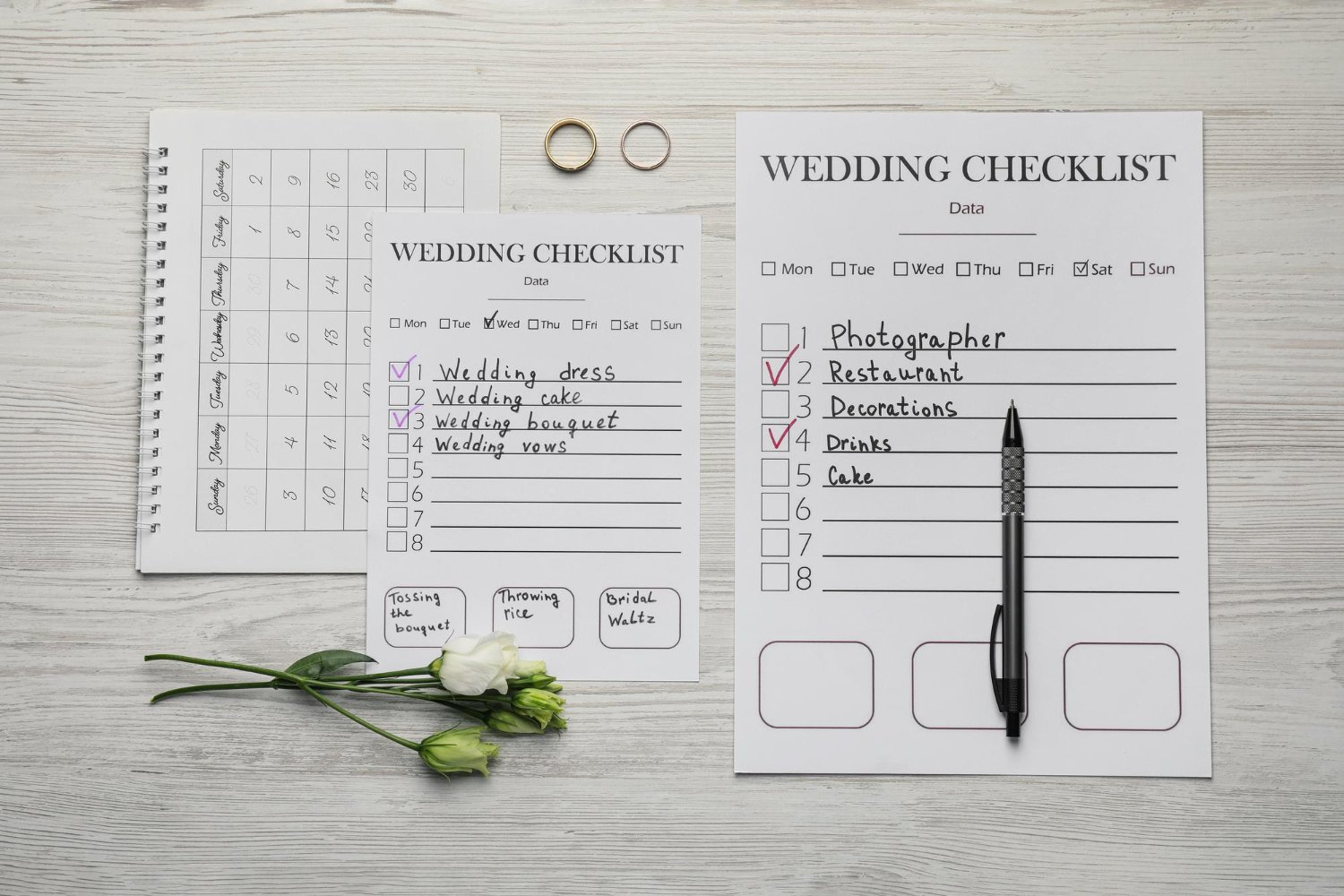 Photo flat lay composition with wedding checklists and calendar on white wooden table