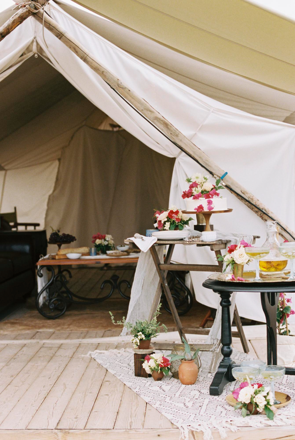 food and drink on tables outside a tent