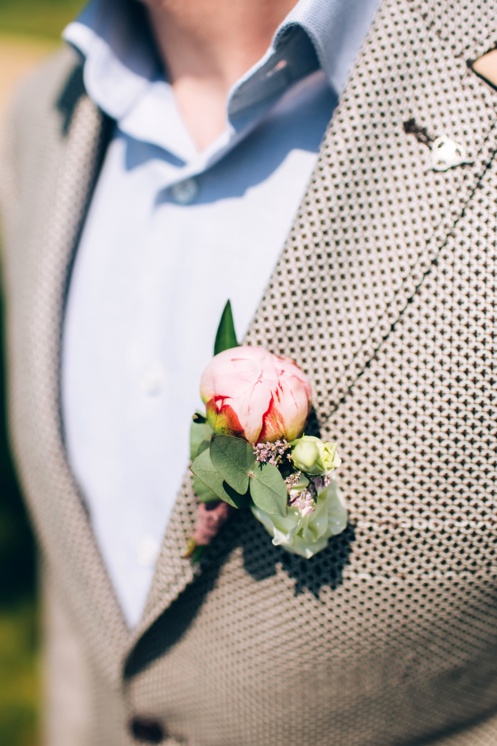 boutonniere on the lapel of his jacket