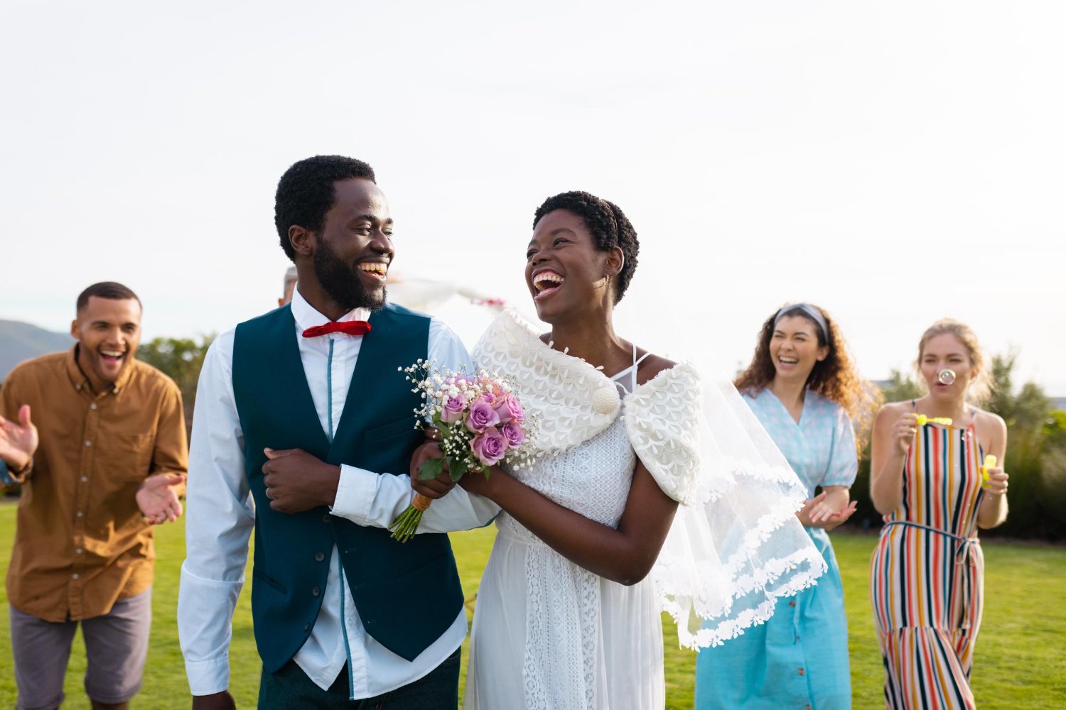 happy african american couple smiling and embracing during wedding