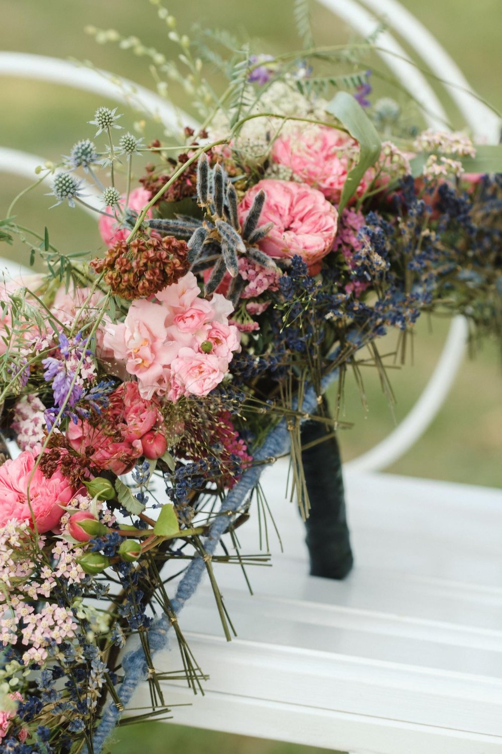 a long wedding bouquet on a frame is on the table