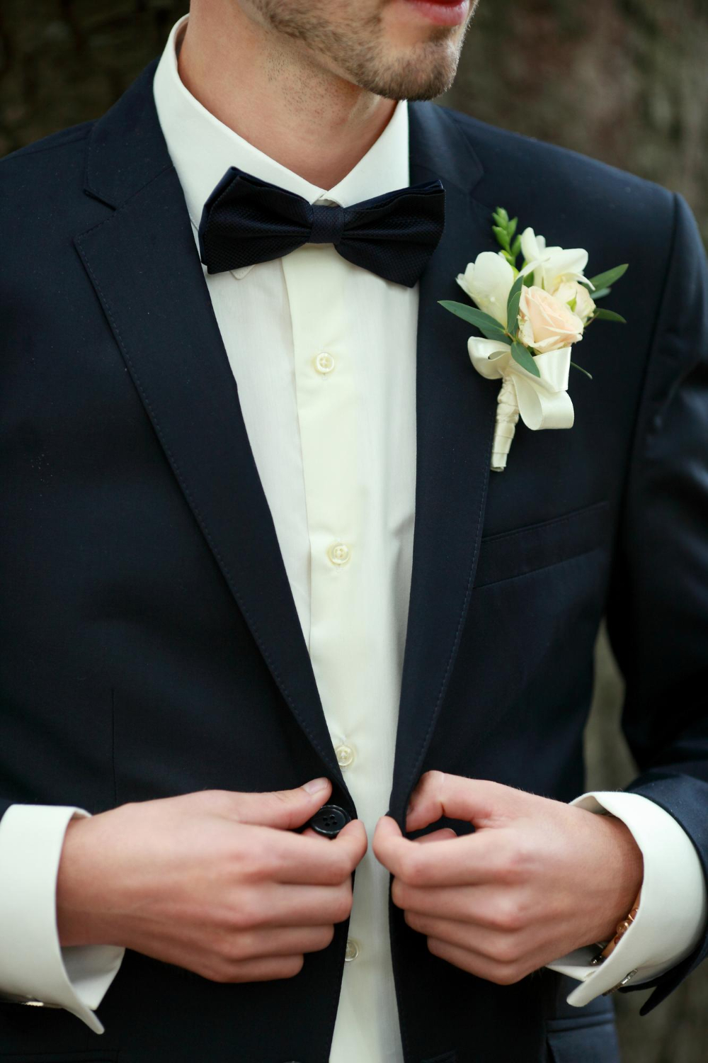posed groom with button holewedding details beautiful boutonniere men's details