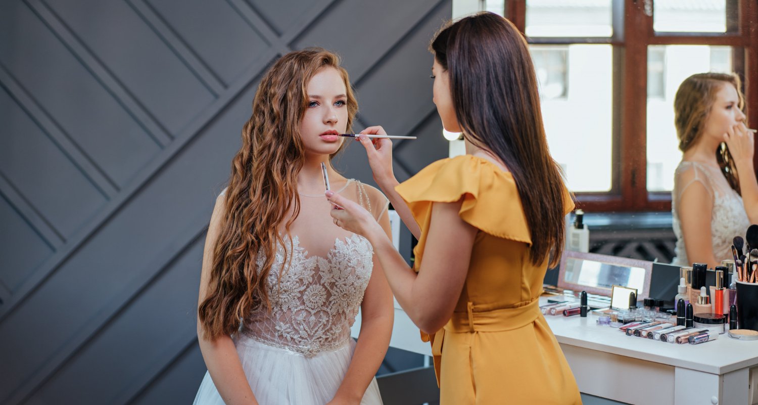 professional makeup and hairstyle artist making makeup for the bride