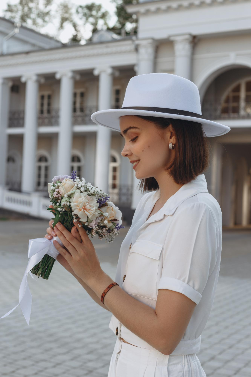 smiling bride in elegant white hat