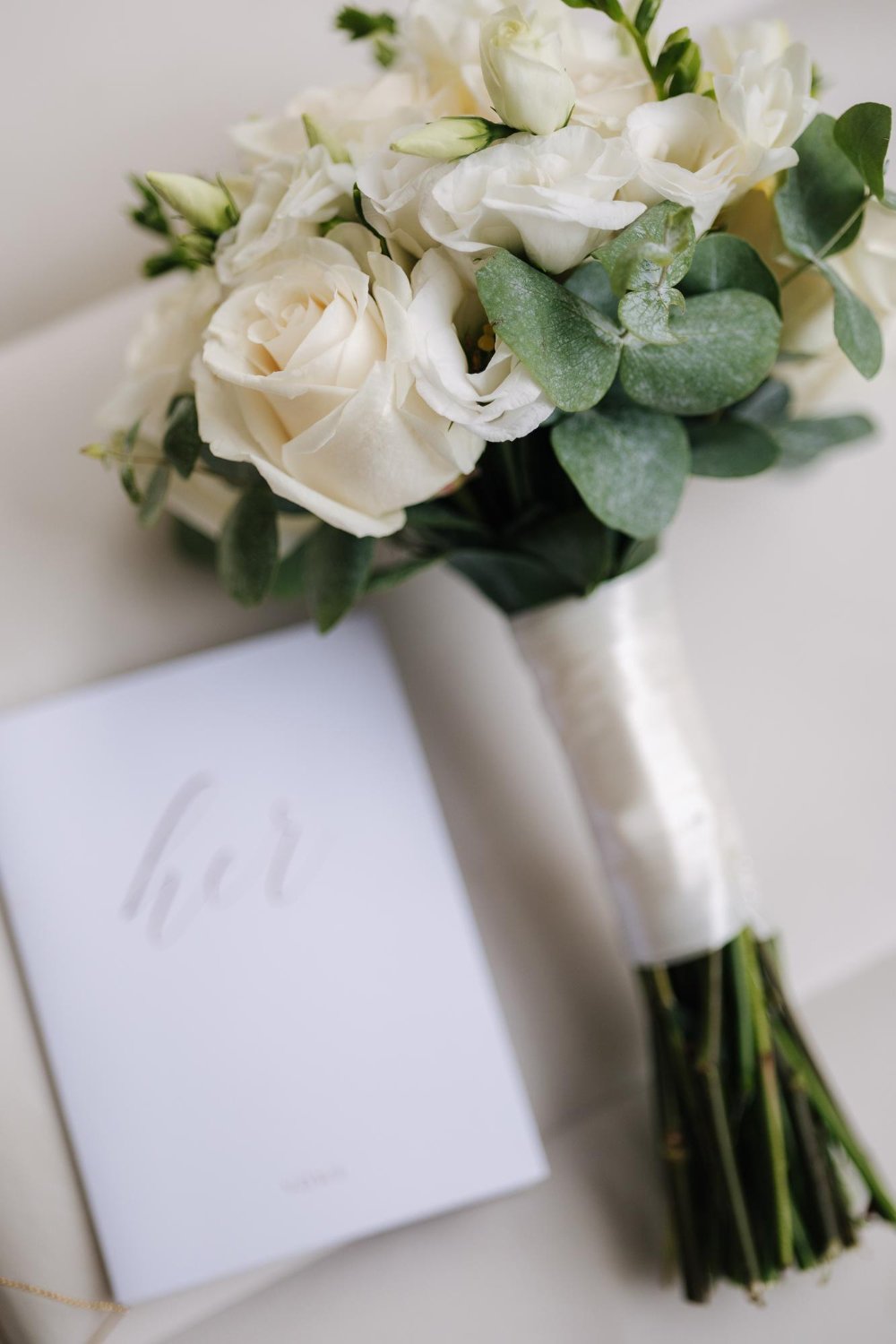 wedding bouquet and vows on chair white roses and eucalyptus beautiful fresh flowers