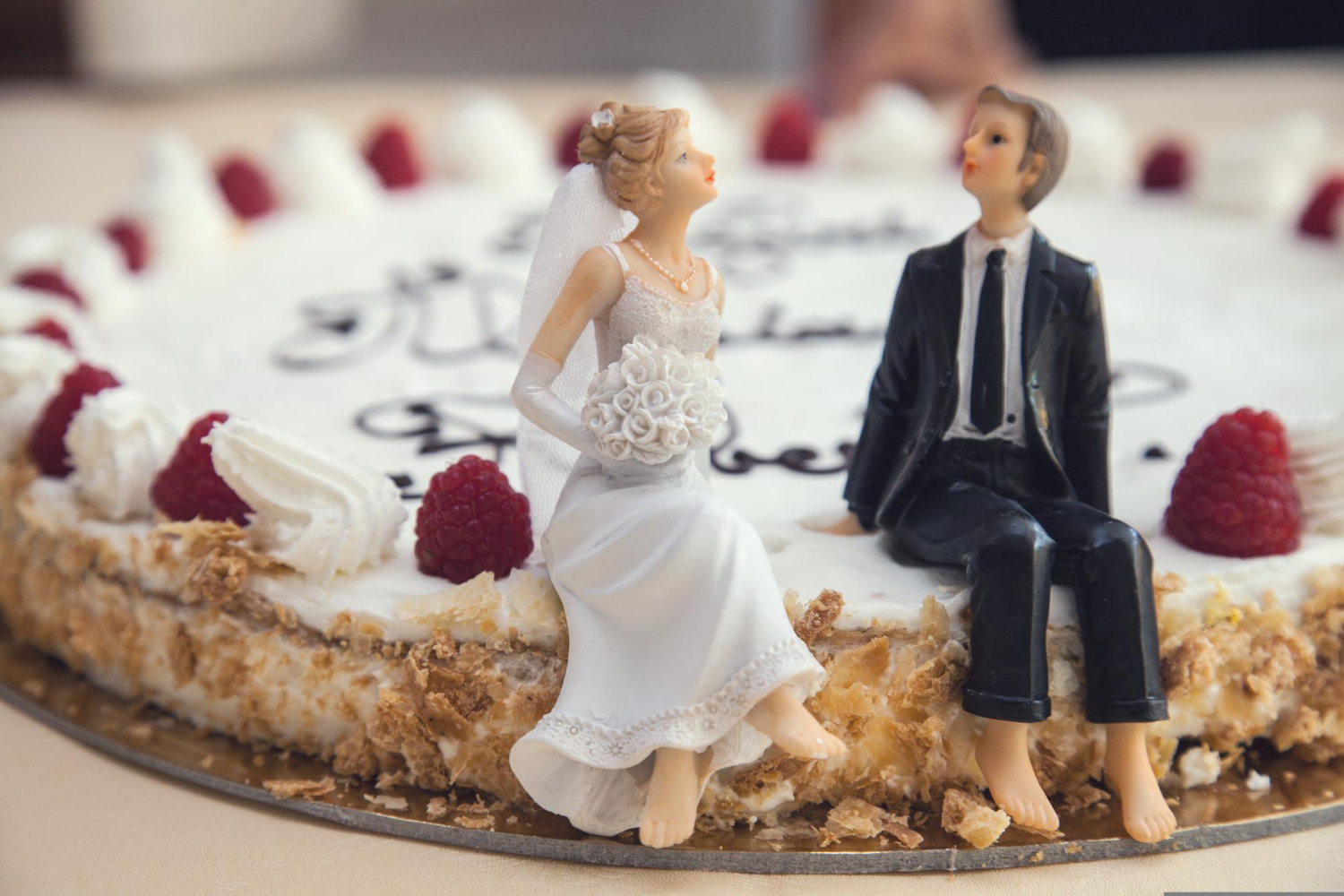 a wedding cake with a figurine of a bride and groom on top of it.