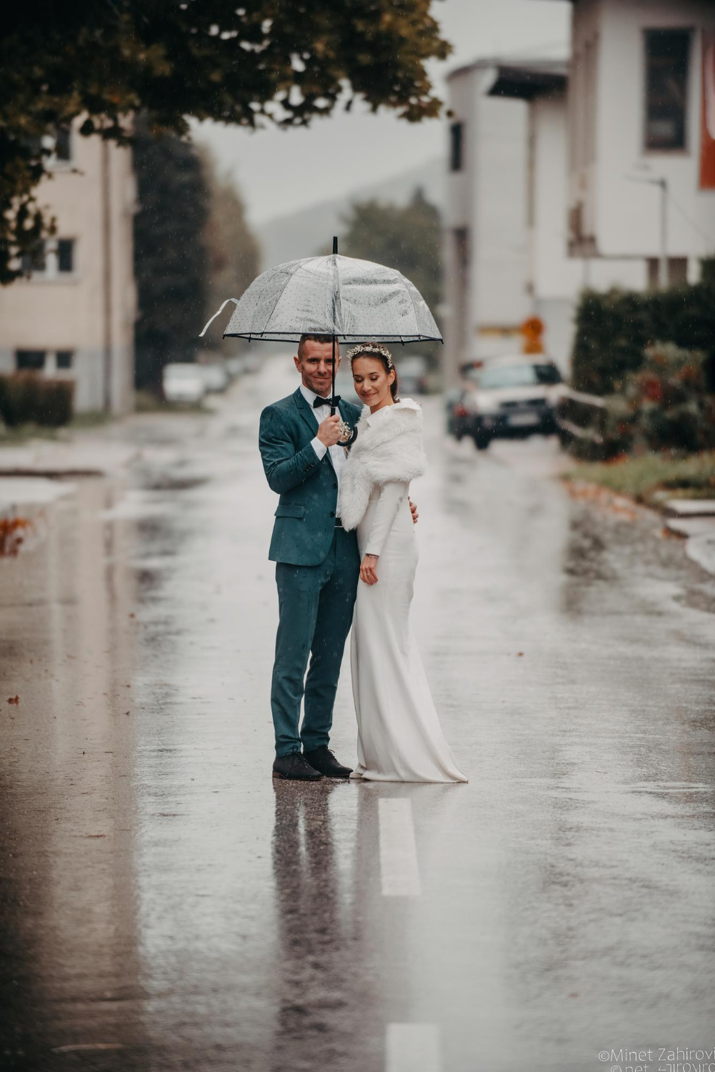 wedding happy moments. a happy young couple, newlyweds walking the streets in rainy weather