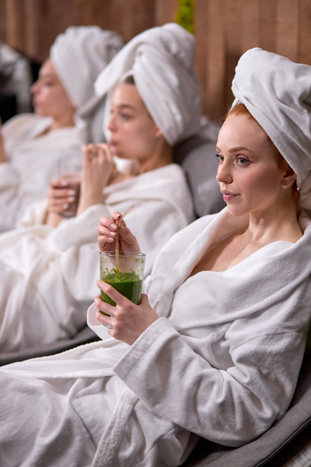 women in bathrobes spending time in spa resort hotel salon